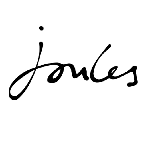 A woman sat in a field against a blue sky wearing a white and yellow striped top, blue jeans and a blue hat from Joules.
